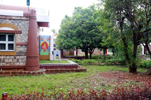 Corner of the treatment block with lawn and mango trees